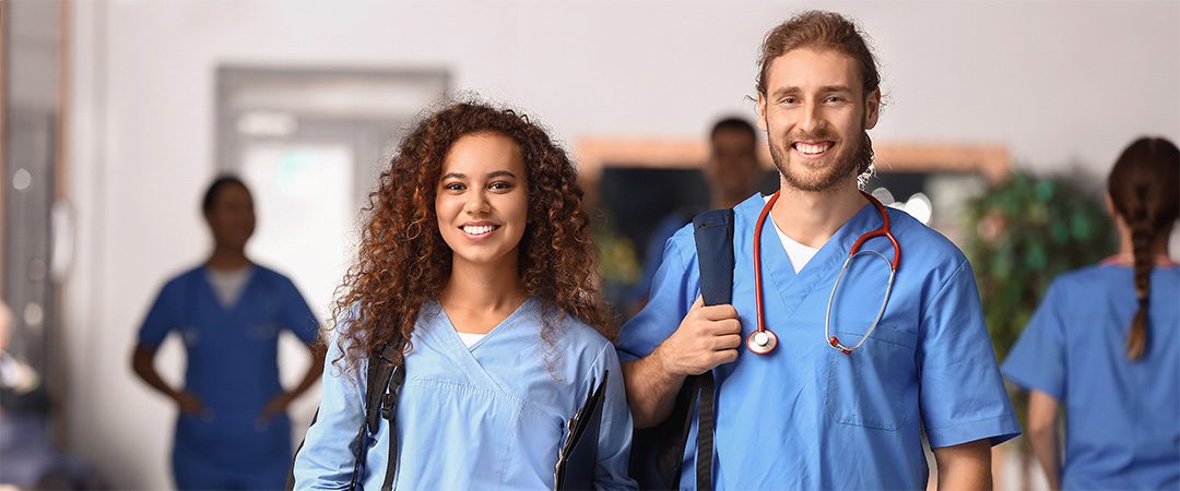 Two nurses reporting for work smiling and happy to be there